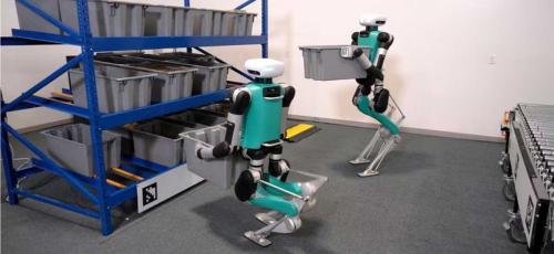 Two Agility Robotics robots lifting and moving crates on a storage shelf.
