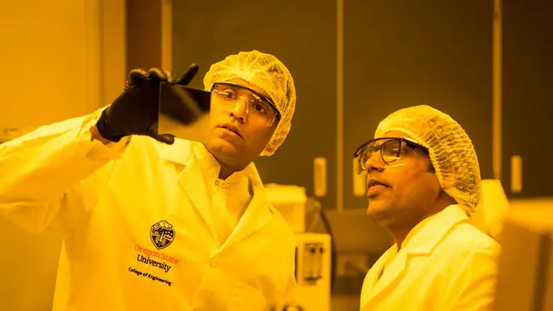 Harish Subbaraman in the lab with another person holding a sample.